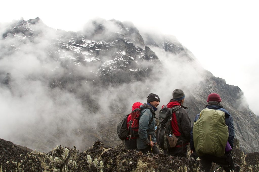 Men climbing a snowy mountain